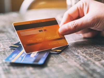 Closeup image of a hand holding credit card