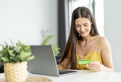 Woman making an online purchase with credit card and computer